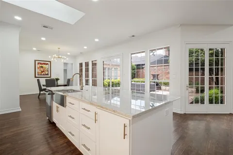 a large kitchen with kitchen island granite countertop a large window