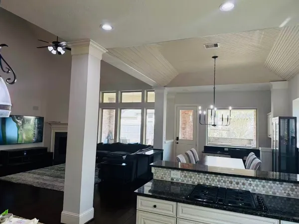 a large kitchen with a counter space a sink and cabinets