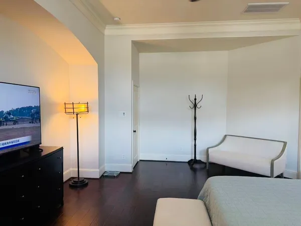 a living room with furniture and a lamp