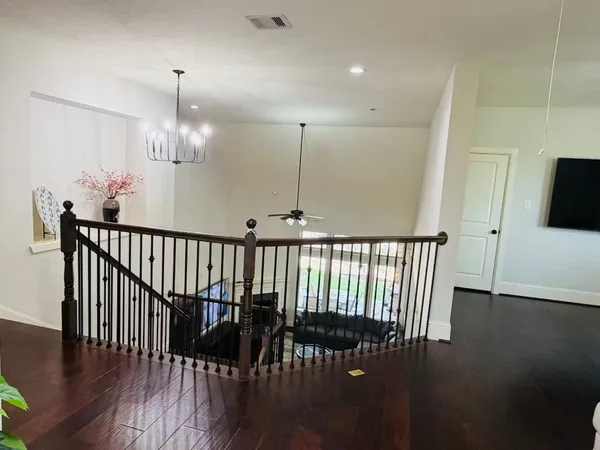 a view of a hallway and wooden floor windows