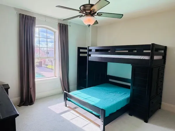 a room with pool table and a ceiling fan