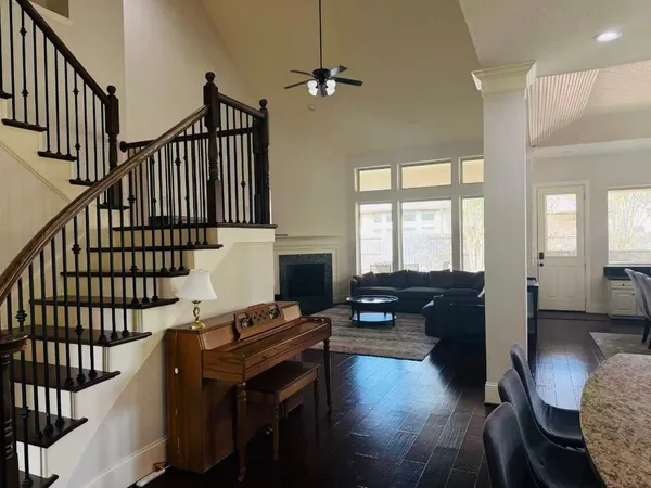 a living room with wooden floor furniture and a window