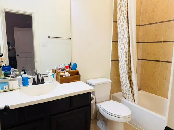 a bathroom with a sink toilet vanity and tub