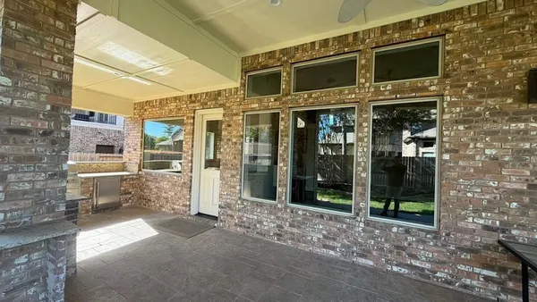 a kitchen with stainless steel appliances granite countertop a sink a stove and a refrigerator