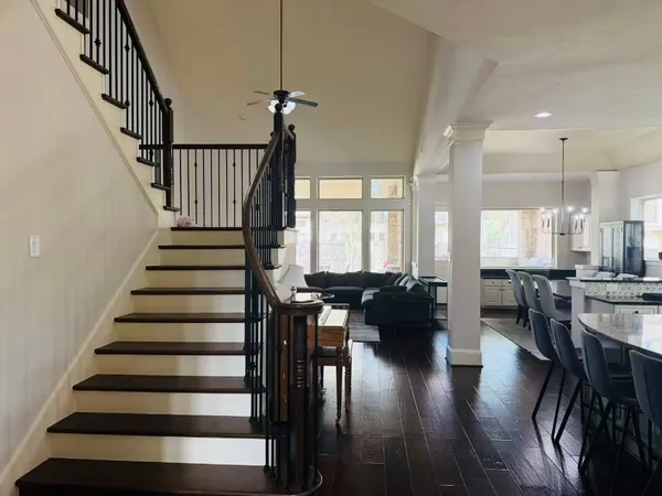 a view of entryway and dining room and hall with wooden floor