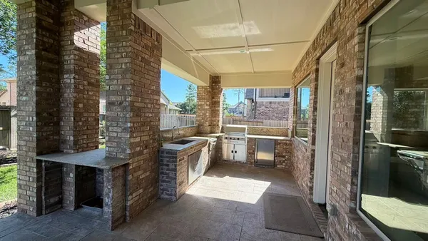a kitchen with kitchen island granite countertop a stove a sink a refrigerator and a dining table with wooden floor