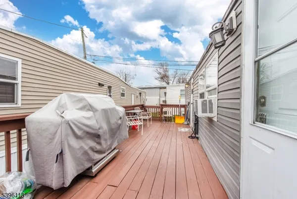 a roof deck with wooden floor and cabinets