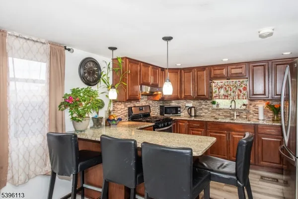 a kitchen with a table chairs and a refrigerator