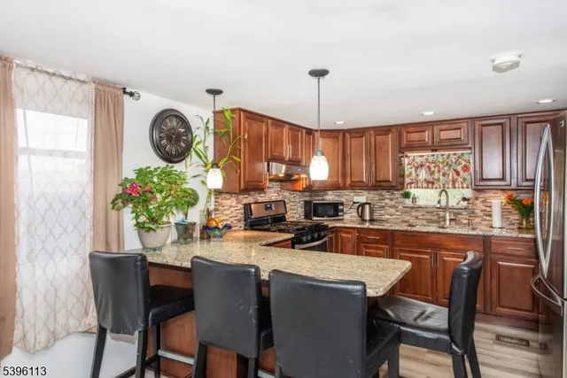 a kitchen with a table chairs and a refrigerator