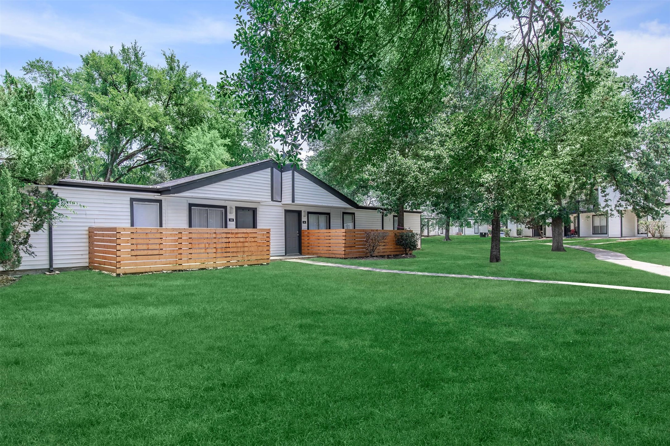 18001 Cypress Trace Road, Unit 2401 Houston, TX 77090 - Photo 25 of 31 a view of a house with a big yard and large trees