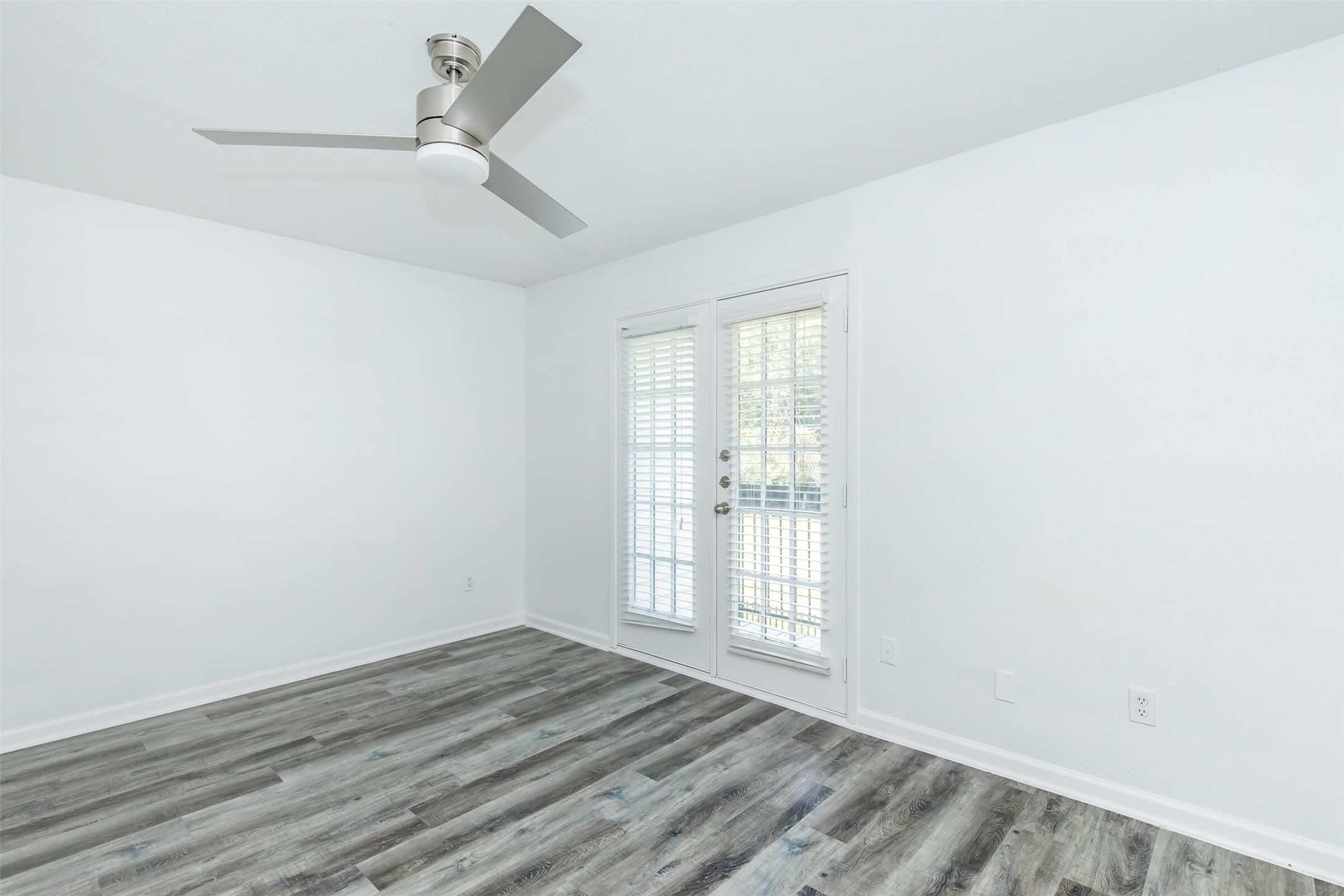 18001 Cypress Trace Road, Unit 2401 Houston, TX 77090 - Photo 7 of 31 an empty room with wooden floor and windows