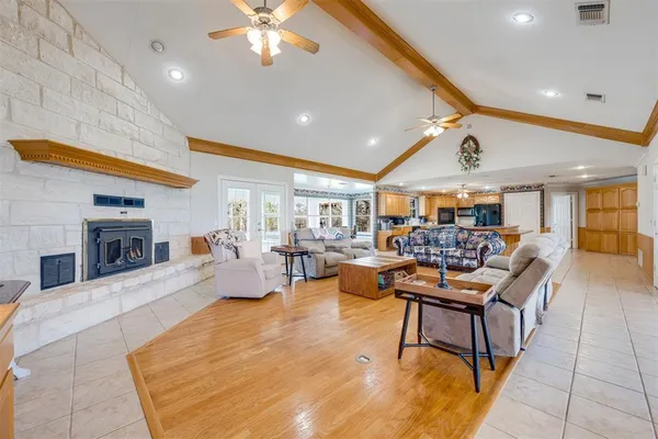 a living room with lots of furniture and view of kitchen