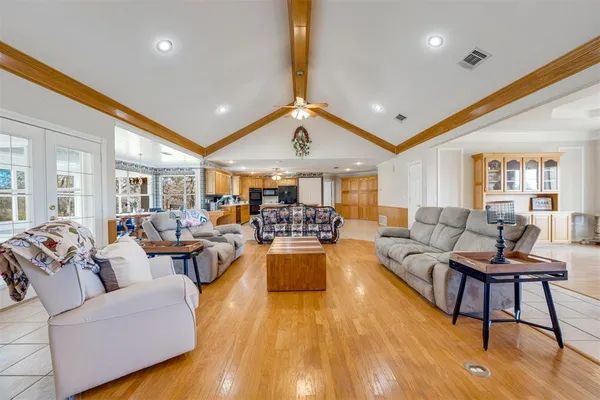 a living room with furniture and a wooden floor