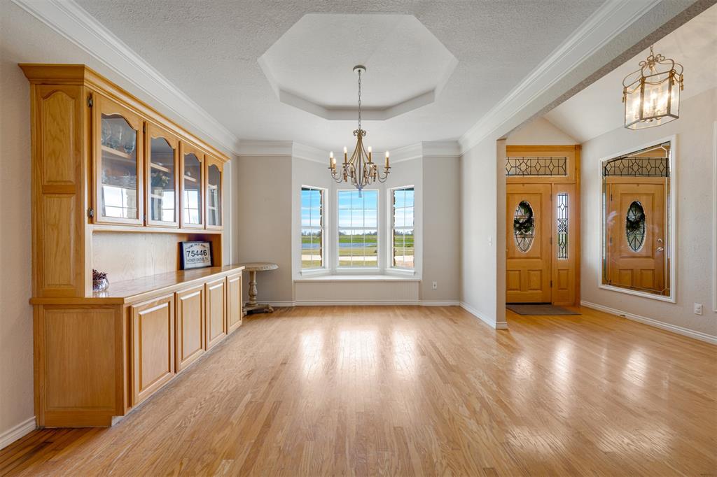 2290 County Road Honey Grove, TX 75446 - Photo 13 of 37 a view of a big room with wooden floor windows and entryway