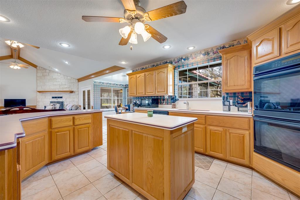 2290 County Road Honey Grove, TX 75446 - Photo 15 of 37 a kitchen with stainless steel appliances granite countertop a sink and a stove