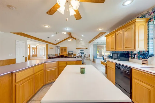 a large kitchen with stainless steel appliances lots of counter space and a sink