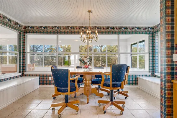 a view of a dining room with furniture large windows and wooden floor