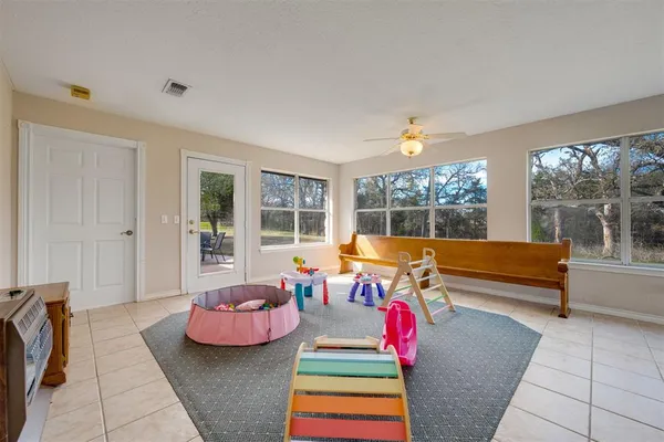 a living room with furniture and a floor to ceiling window