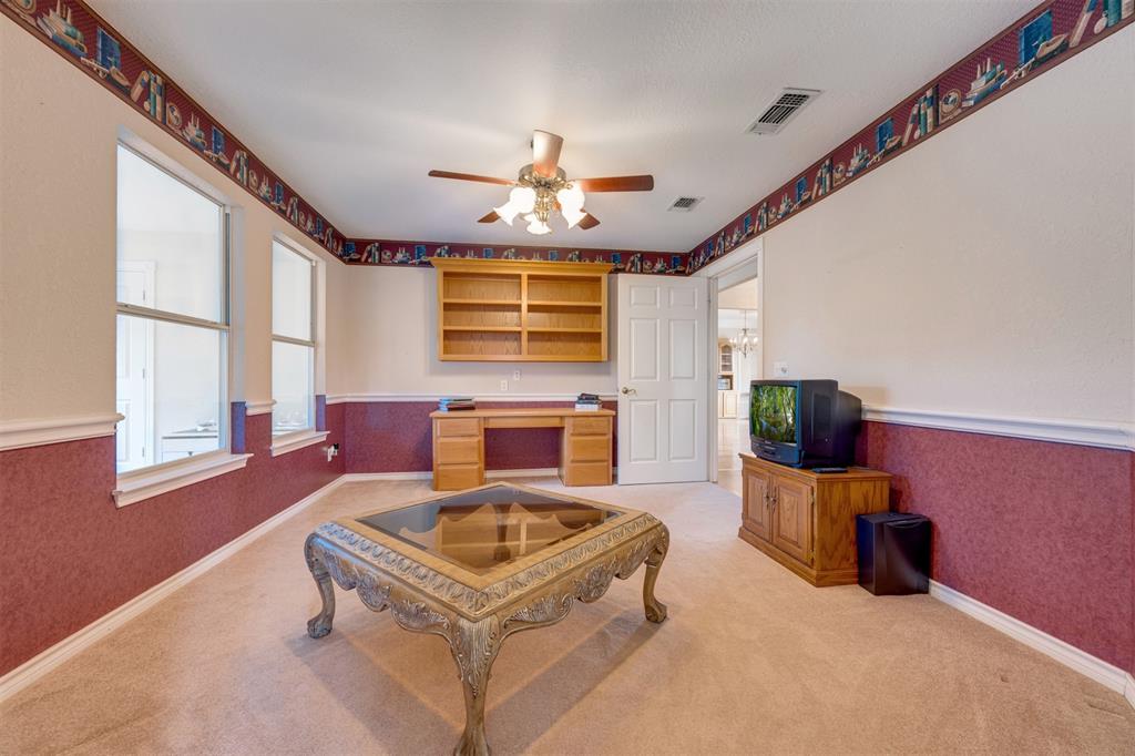 2290 County Road Honey Grove, TX 75446 - Photo 23 of 37 a living room with furniture a fireplace and a flat screen tv