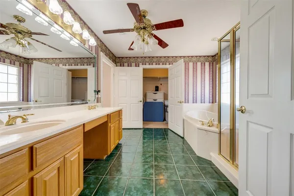 a spacious bathroom with a double vanity sink and a large mirror