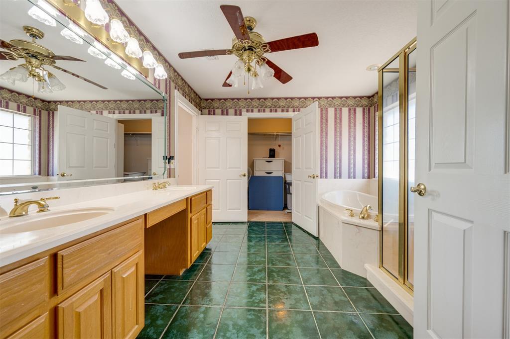 2290 County Road Honey Grove, TX 75446 - Photo 26 of 37 a spacious bathroom with a double vanity sink and a large mirror
