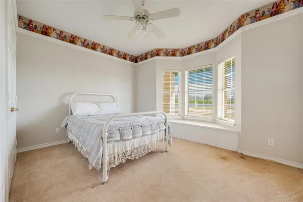 a spacious bedroom with a bed and a window