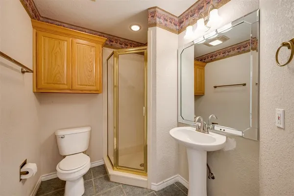 a bathroom with a sink toilet and shower