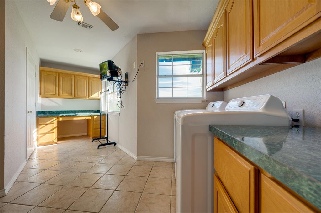 2290 County Road Honey Grove, TX 75446 - Photo 31 of 37 a kitchen with stainless steel appliances granite countertop a sink a stove and a refrigerator