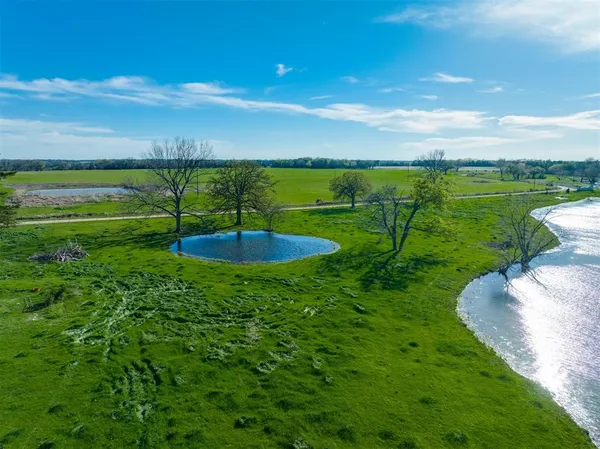 a view of a lake with houses in the background