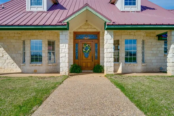 a front view of a house with garden