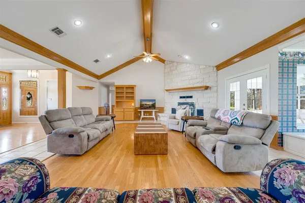 a living room with furniture and a wooden floor