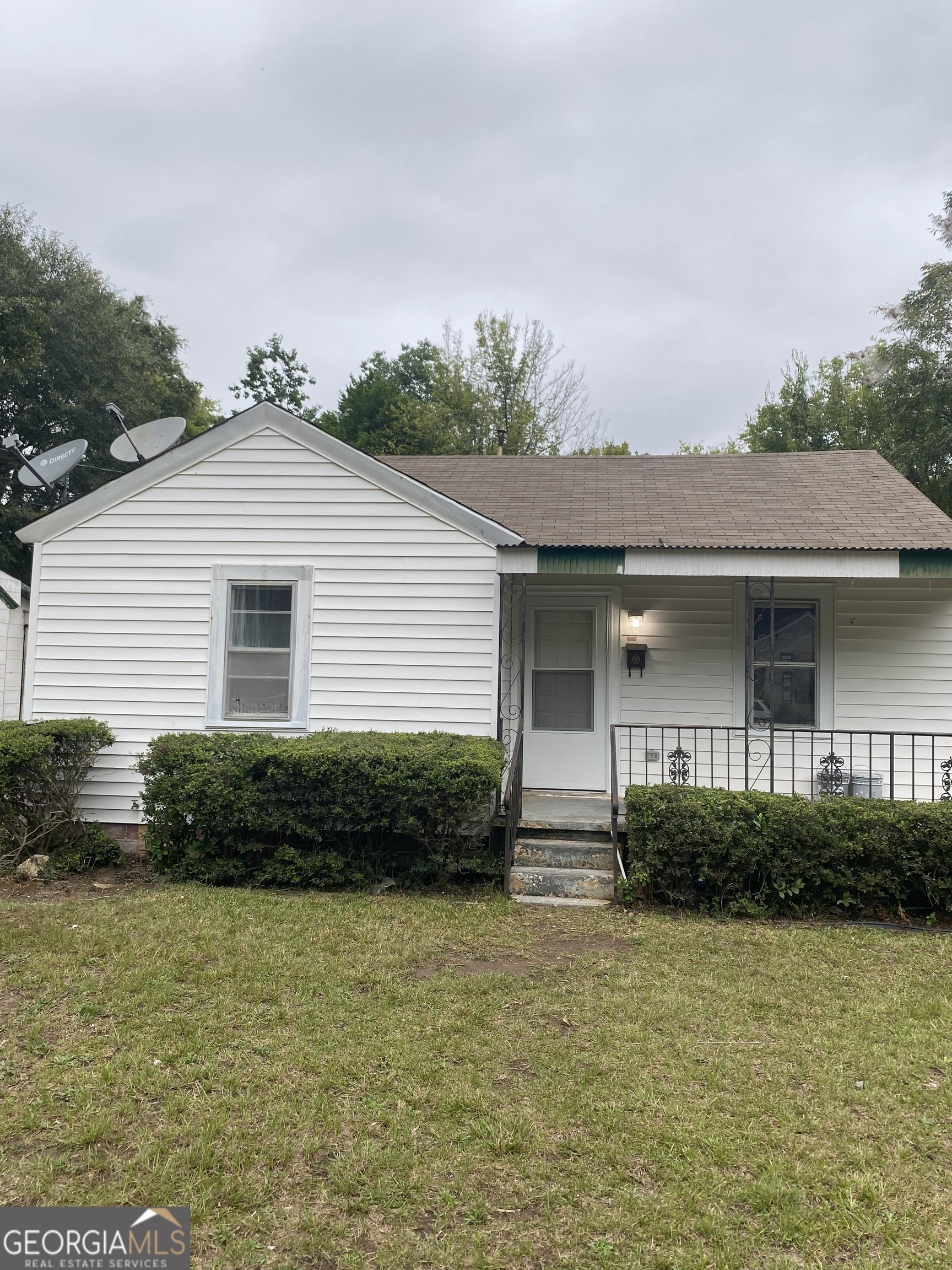 a front view of a house with garden