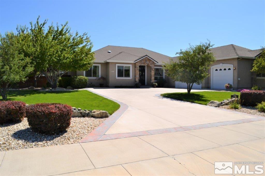 a front view of a house with a yard