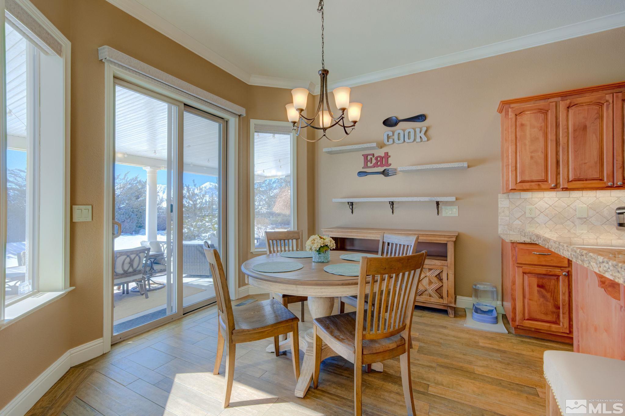 1122 North Fork Trail Minden, NV 89423 - Photo 12 of 40 a view of a dining room with furniture window and wooden floor