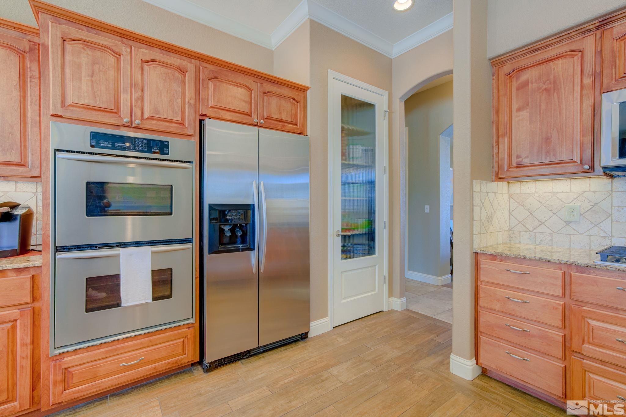 1122 North Fork Trail Minden, NV 89423 - Photo 13 of 40 a kitchen with stainless steel appliances granite countertop a refrigerator and cabinets
