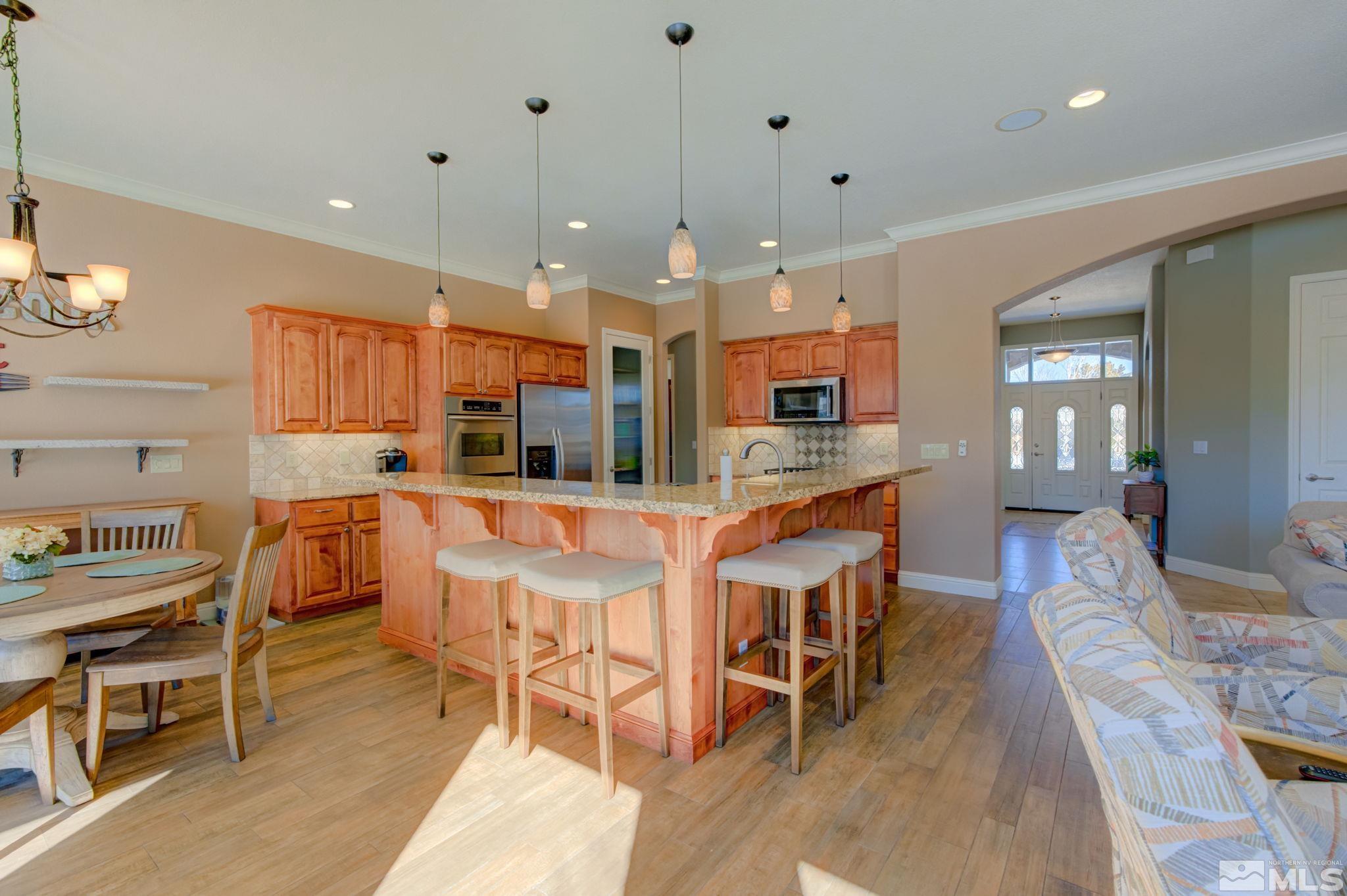 1122 North Fork Trail Minden, NV 89423 - Photo 18 of 40 a large kitchen with a table and chairs