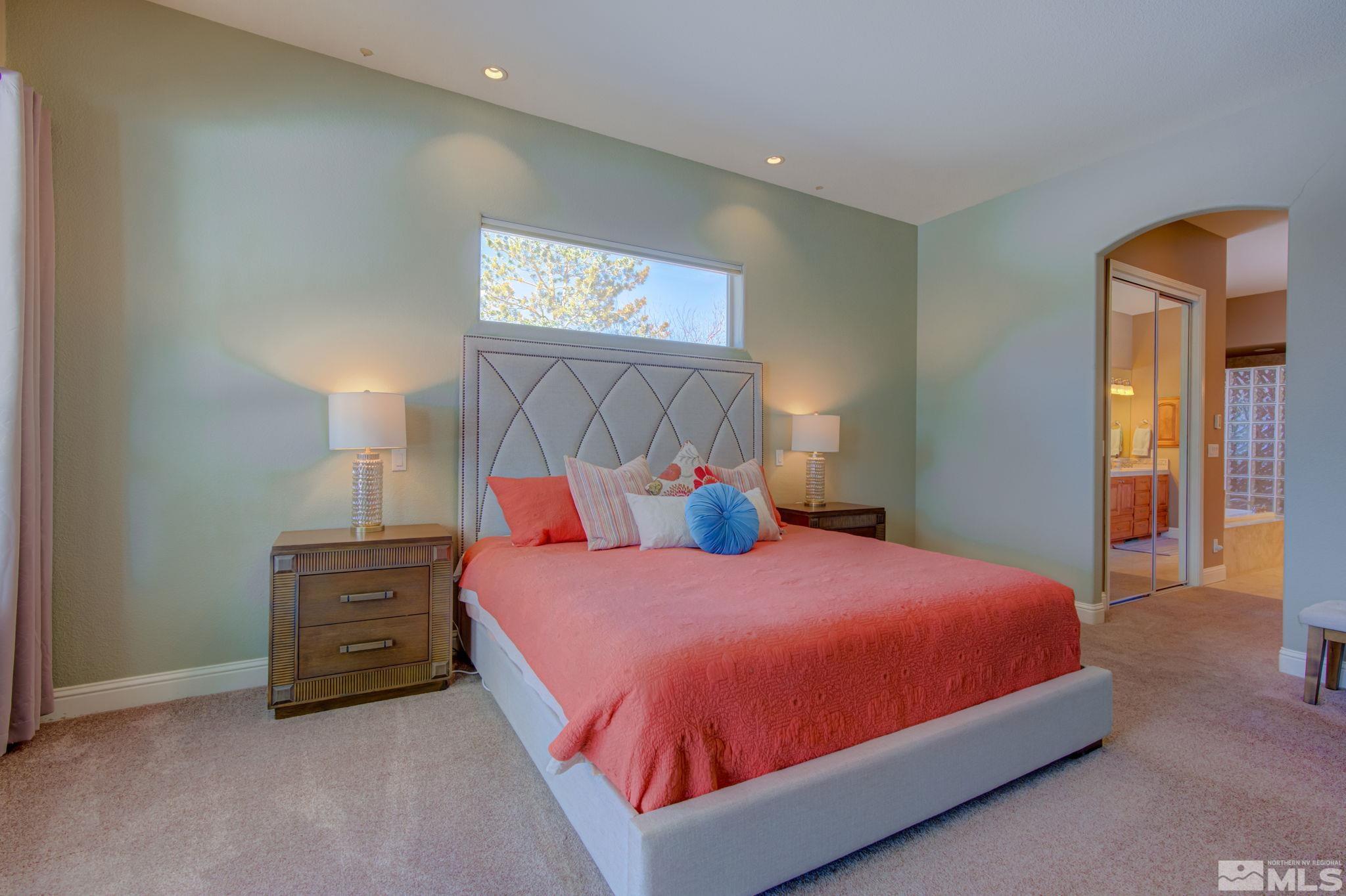 1122 North Fork Trail Minden, NV 89423 - Photo 22 of 40 a bedroom with a bed and a lamp on table