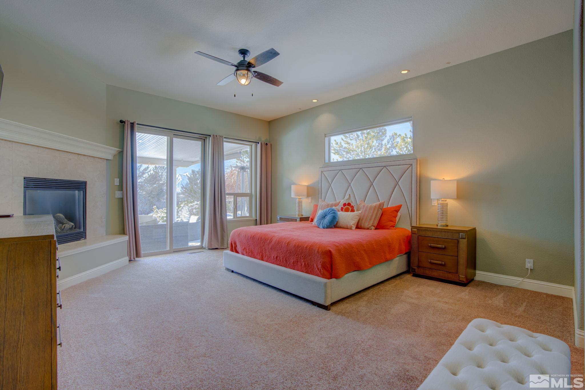 1122 North Fork Trail Minden, NV 89423 - Photo 23 of 40 a spacious bedroom with a large bed and a chandelier