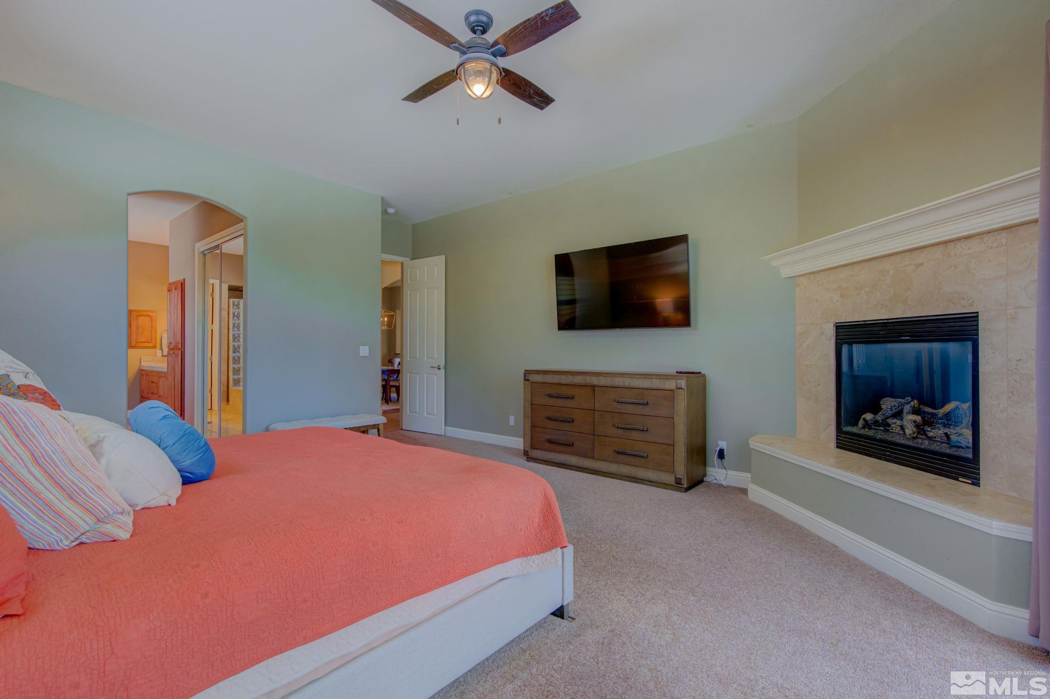 1122 North Fork Trail Minden, NV 89423 - Photo 24 of 40 a bedroom with a bed and a television in it