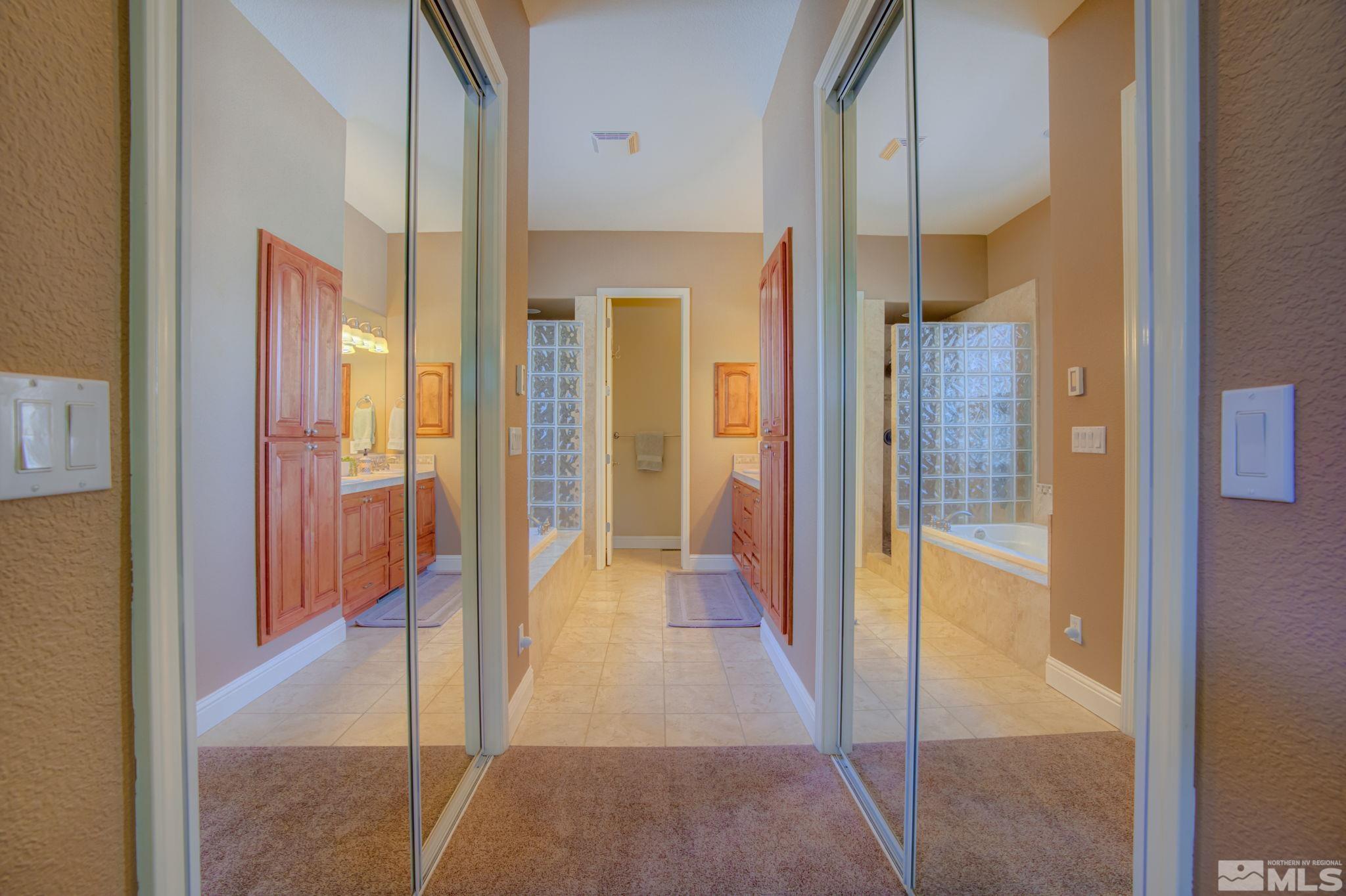 1122 North Fork Trail Minden, NV 89423 - Photo 25 of 40 a view of a hallway with a glass door shower