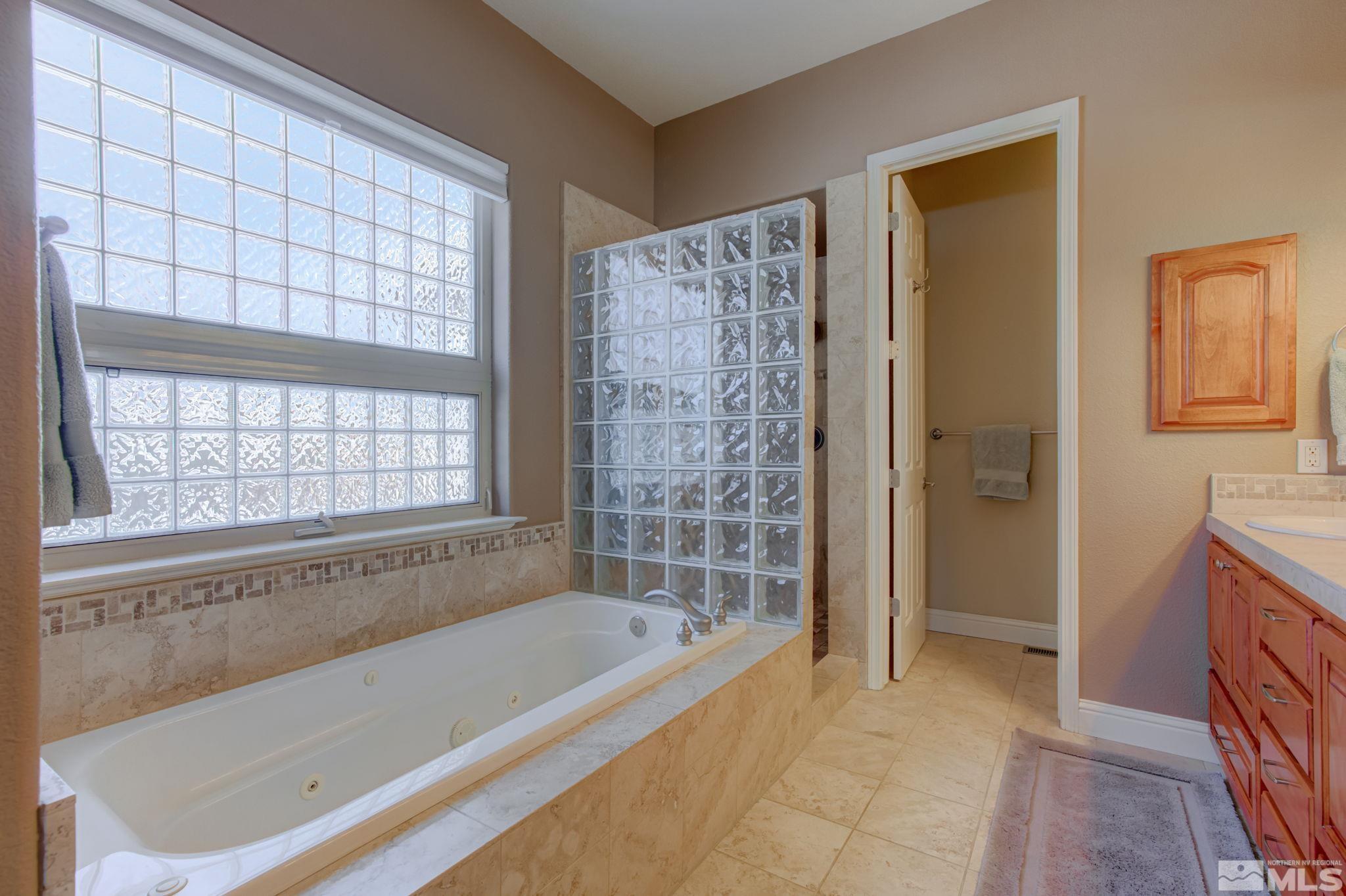 1122 North Fork Trail Minden, NV 89423 - Photo 26 of 40 a bathroom with a bathtub and shower