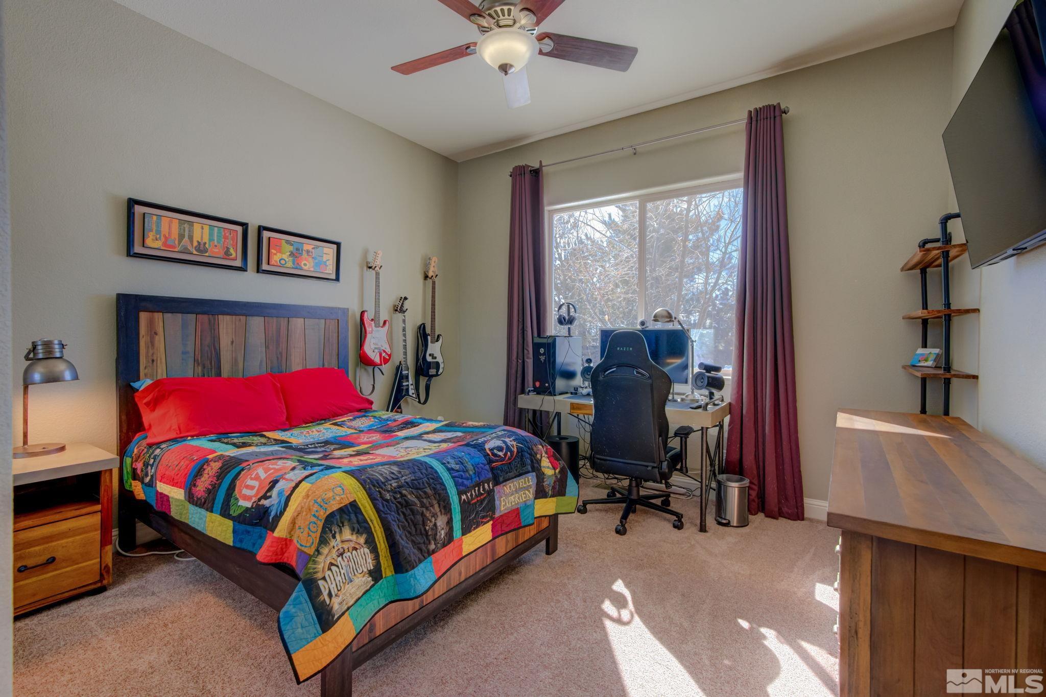 1122 North Fork Trail Minden, NV 89423 - Photo 29 of 40 a bedroom with a bed and a chandelier