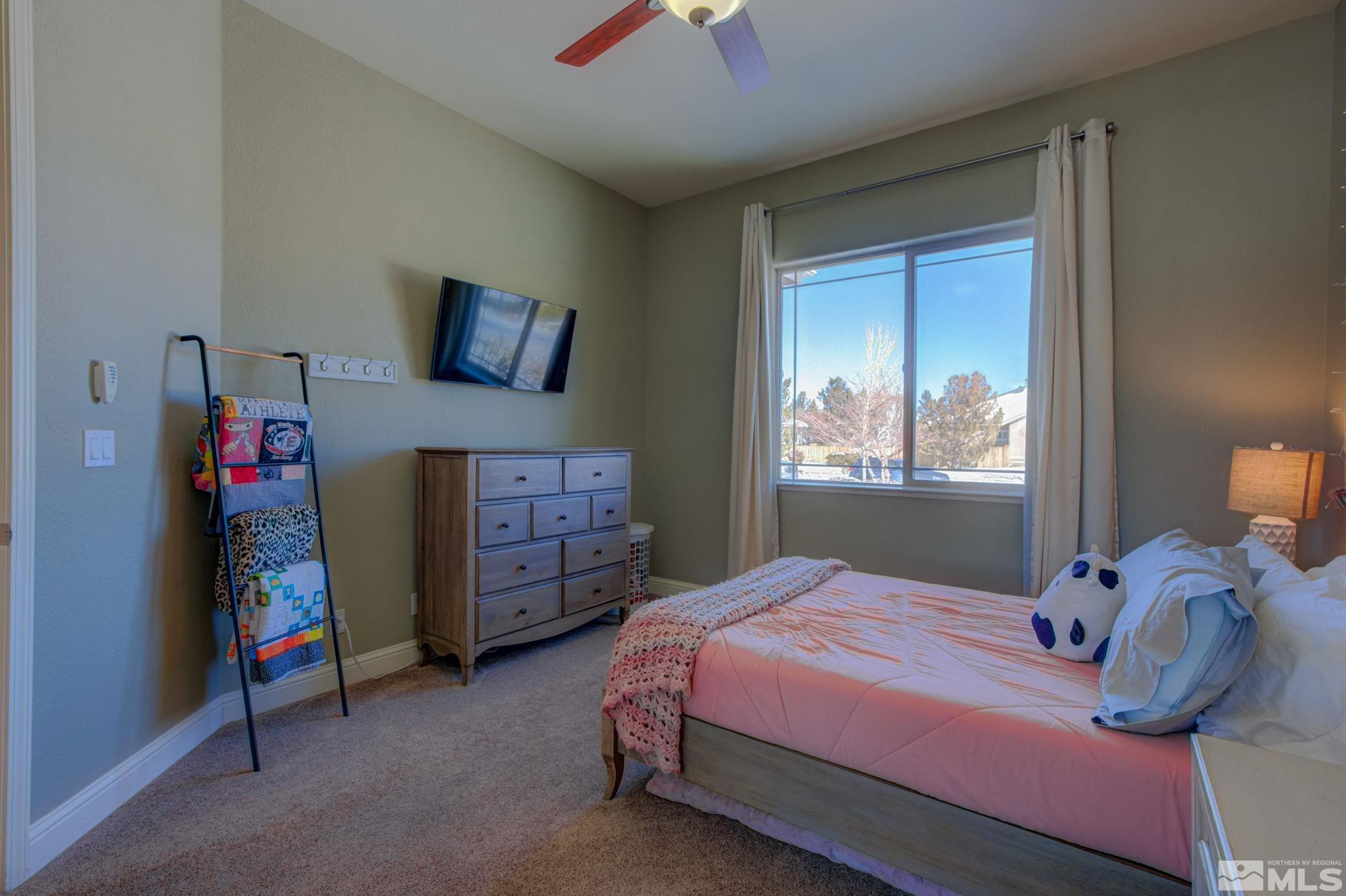 1122 North Fork Trail Minden, NV 89423 - Photo 30 of 40 a bedroom with a bed and a chandelier