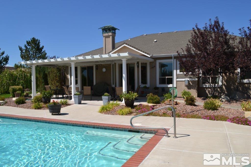 1122 North Fork Trail Minden, NV 89423 - Photo 36 of 40 a view of a house with backyard sitting area and garden