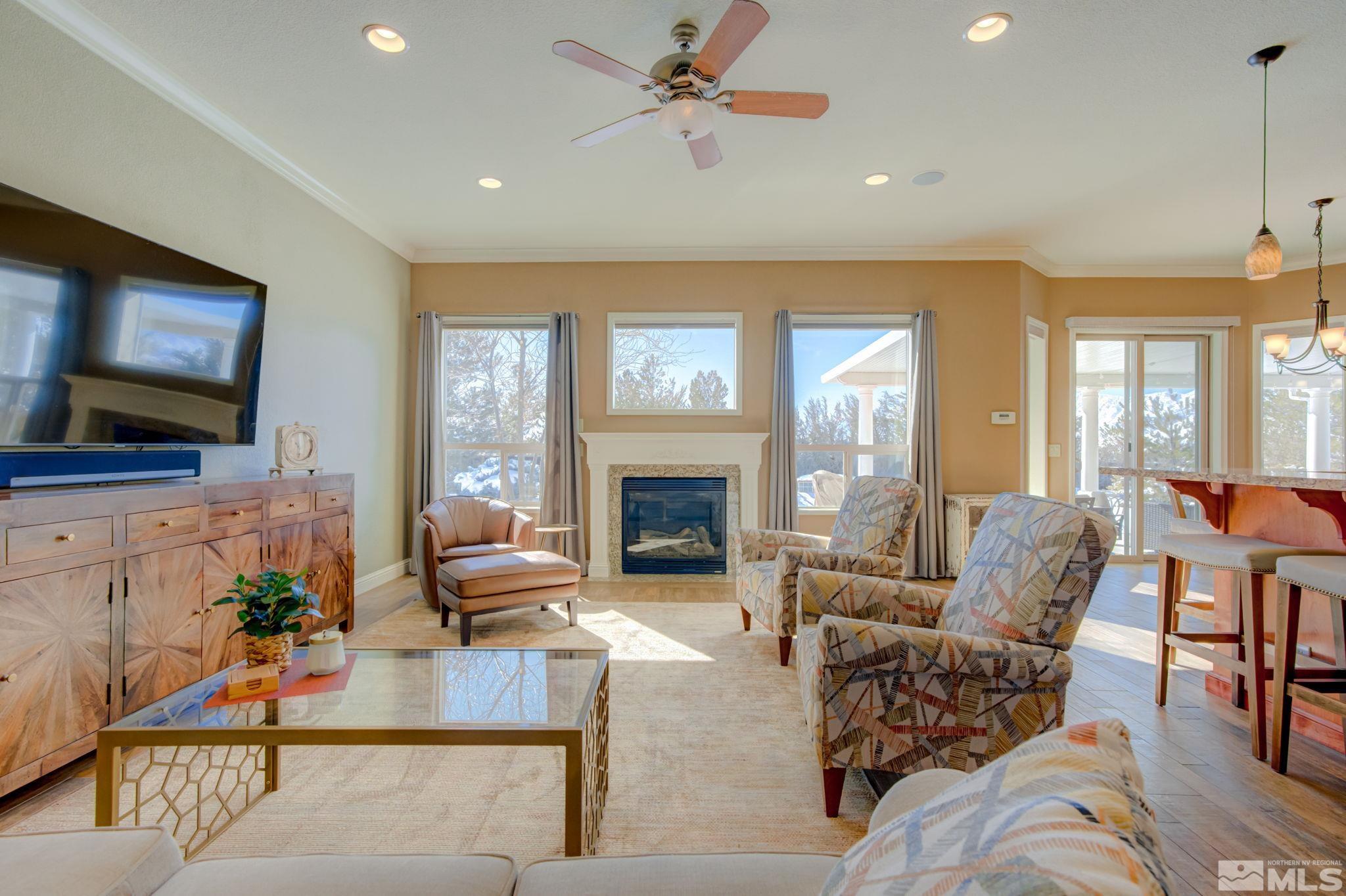 1122 North Fork Trail Minden, NV 89423 - Photo 5 of 40 a living room with furniture a flat screen tv and a fireplace