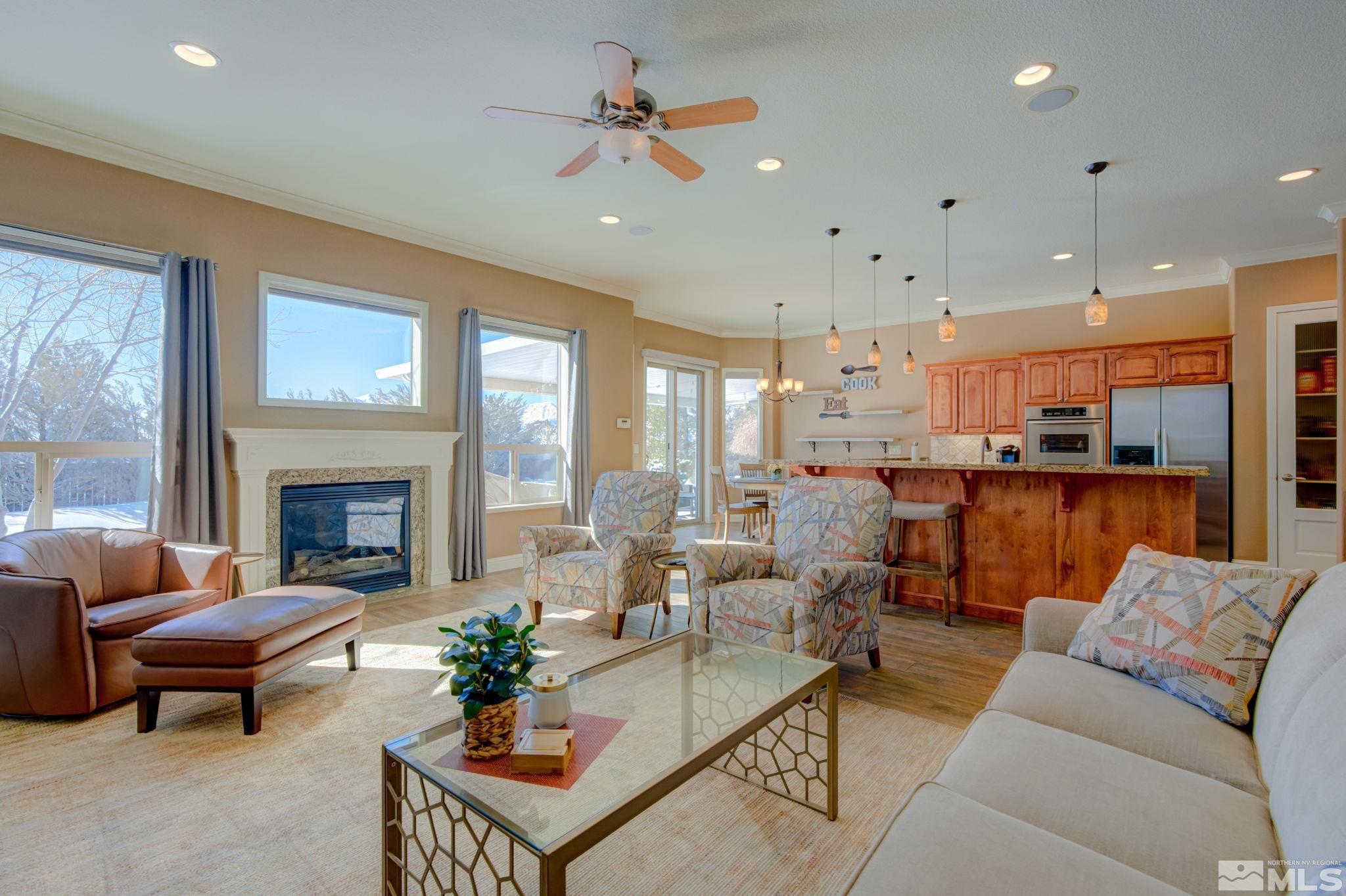 1122 North Fork Trail Minden, NV 89423 - Photo 8 of 40 a living room with furniture fireplace and a view of kitchen