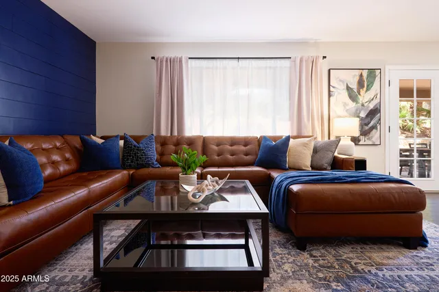 a view of living room with furniture and wooden floor