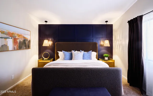 a bedroom with a bed and a walk in closet with wooden floor