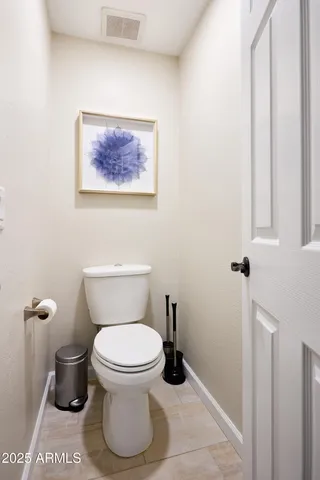 a bedroom with a bed a mirror and a window