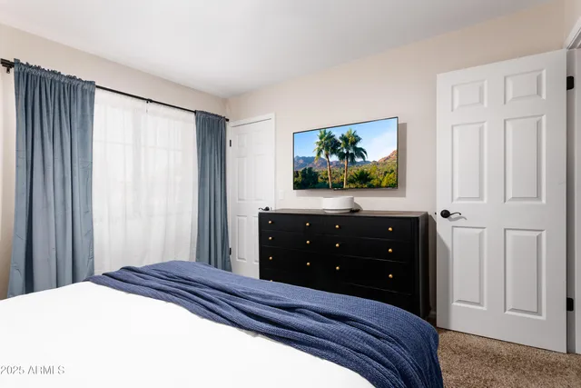 a bedroom with a bed and a window